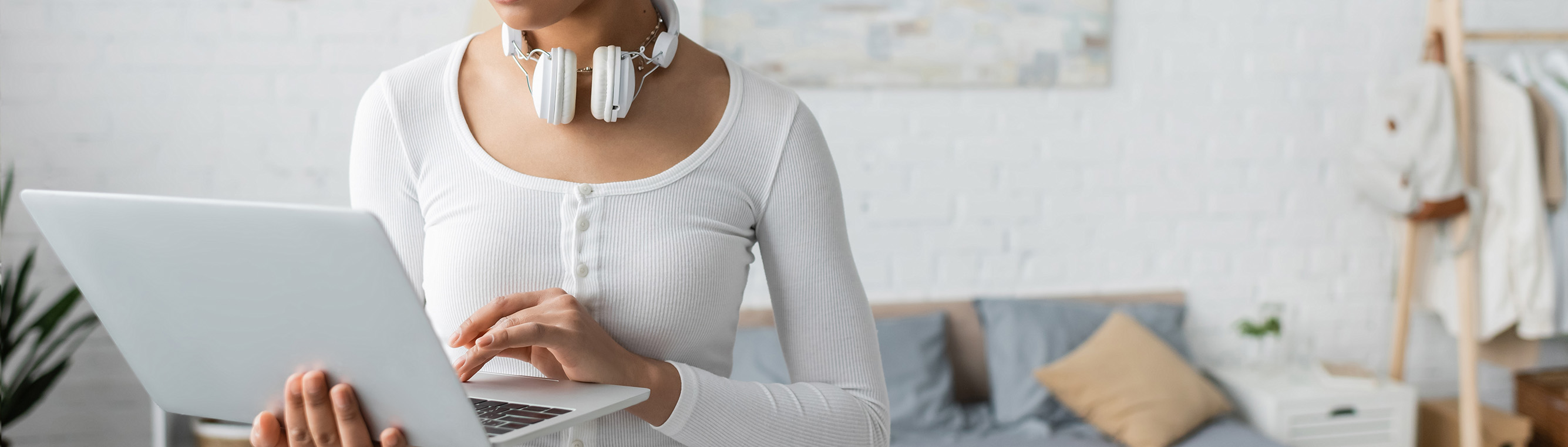 A woman with headphones and a laptop.